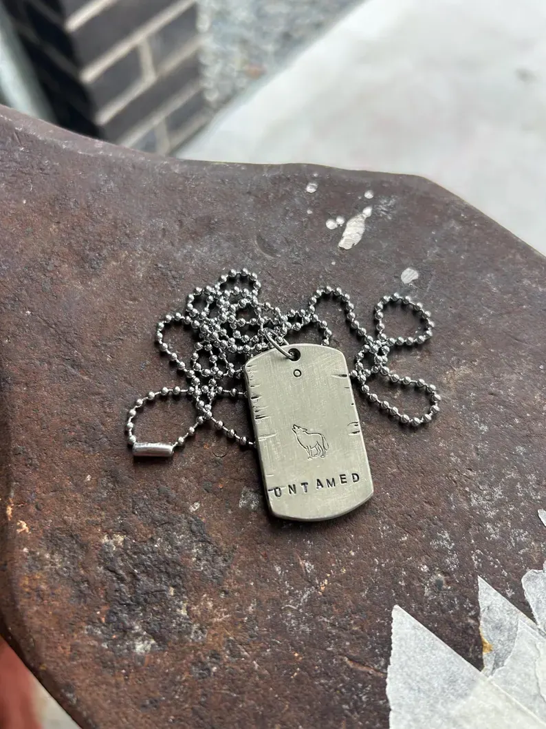 A hand-stamped Hammer & Heart pendant on workshop tools